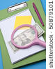 stock photo magnifying glass analysis of business or education costs 50879101